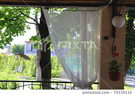 Summer restaurant terrace or veranda interior with open space. Grass decor and garden view. Summer restaurant terrace or veranda interior with open space. Grass decor and garden view. 79339116