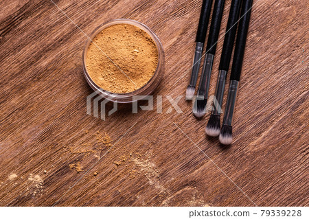 Mineral powder foundation with brushes on a wooden background. Eco-friendly and organic beauty products Mineral powder foundation with brushes on a wooden background. Eco-friendly and organic beauty products 79339228