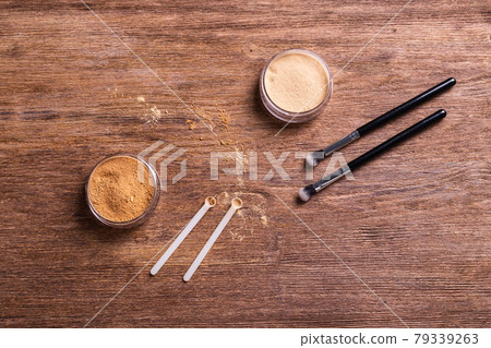 Mineral powder foundation with brushes on a wooden background. Eco-friendly and organic beauty products 79339263