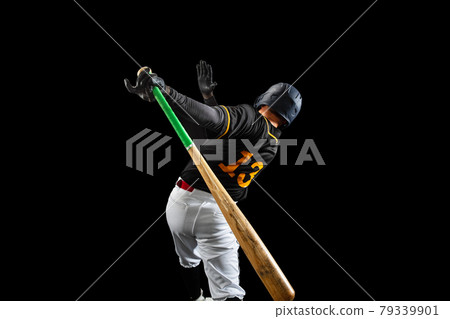 Professional baseball player, pitcher in sports uniform and equipment playing baseball isolated on black studio background in neon light. Rear view 79339901