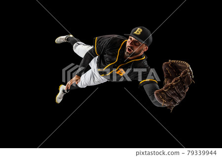 Flying. Baseball player, catcher in sports uniform and equipment practicing isolated on a black studio background. Team sport concept 79339944