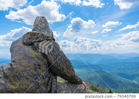 A lone tourist enjoying the mountain landscape in complete peace and harmony 79340709