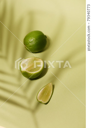 Fresh lime and slice, Isolated on light green background 79340773
