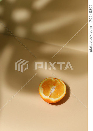 Slice of fresh orange isolated on beige background 79340803