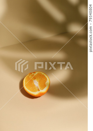 Slice of fresh orange isolated on beige background 79340804