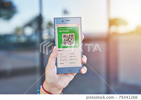 Hand woman holds smartphone displaying an app negative test result of covid-19. Express PCR test, digital result on mobile application Hand woman holds smartphone displaying an app negative test result of covid-19. Express PCR test, digital result on mobile application 79341266