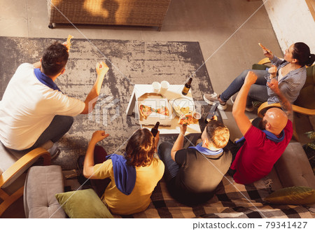 Company of friends watching TV, sport match together. Concept of friendship, leisure activity, emotions Company of friends watching TV, sport match together. Concept of friendship, leisure activity, emotions 79341427