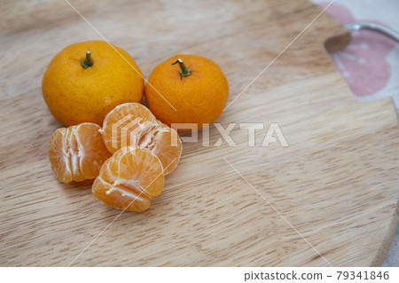 Fresh juicy clementine mandarins on wooden board Fresh juicy clementine mandarins on wooden board 79341846