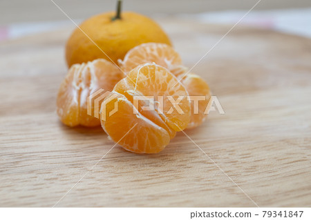 Fresh juicy clementine mandarins on wooden board Fresh juicy clementine mandarins on wooden board 79341847