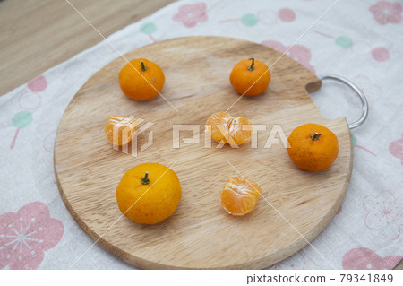 Fresh juicy clementine mandarins on wooden board	 79341849