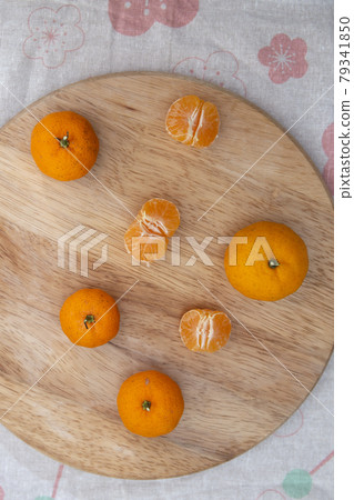 Fresh juicy clementine mandarins on wooden board	 79341850