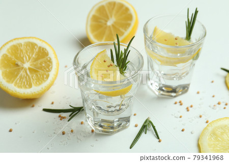 Shots of tequila on white background, close up Shots of tequila on white background, close up 79341968