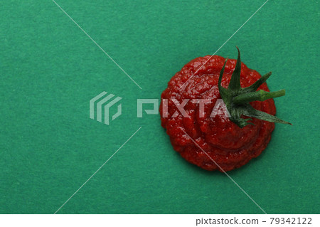 Fresh tomato paste on green background, space for text Fresh tomato paste on green background, space for text 79342122