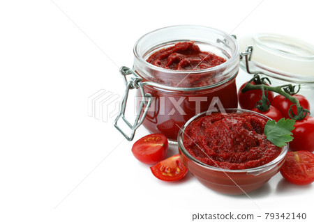 Bowl and jar of tomato paste, and tomatoes isolated on white background Bowl and jar of tomato paste, and tomatoes isolated on white background 79342140