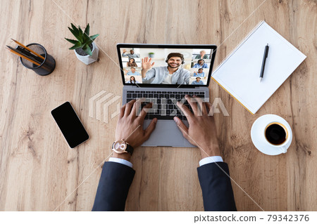 Unrecognizable Black Businessman Having Video Call On Laptop With Multiethnic Colleagues Unrecognizable Black Businessman Having Video Call On Laptop With Multiethnic Colleagues 79342376