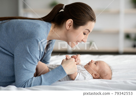 Mother-Child Connection. Happy Loving Young Mommy Bonding With Newborn Child At Home 79342553