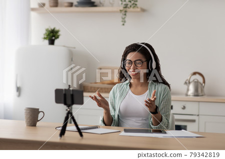 Businesswoman teacher lecturer recording educational video, greeting students at online lesson 79342819