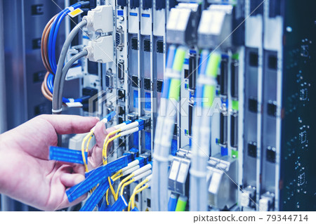 Technician using digital tablet in server room, repair card mainboard checking network link status 79344714