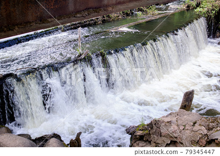 Water in a small waterfall in the forest 79345447