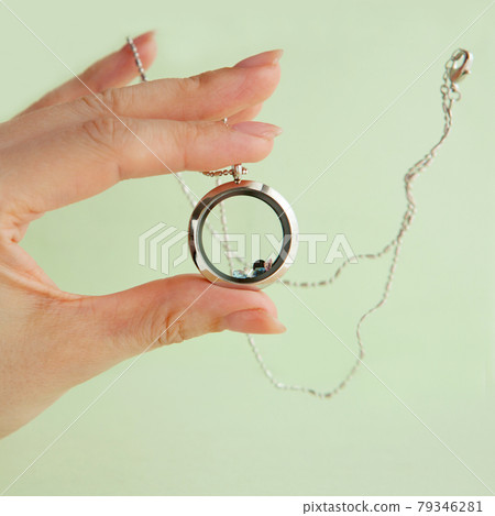 Silver necklace for her shining on womans hand. Luxury silver jewelry chains with glass and crystals. Small Beautiful precious metal present for woman. Luxury jewelry gift Silver necklace for her shining on womans hand. Luxury silver jewelry chains with glass and crystals. Small Beautiful precious metal present for woman. Luxury jewelry gift 79346281