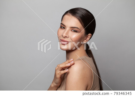 Cheerful young woman with natural manicured nails smiling on white background, studio portrait 79346345