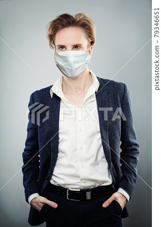 Handsome man wearing suit and surgical face mask, Covid-19 coronavirus concept 79346651