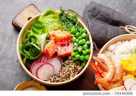 Poke bowls with shrimps, salmon, avocado and mango Poke bowls with shrimps, salmon, avocado and mango 79346906