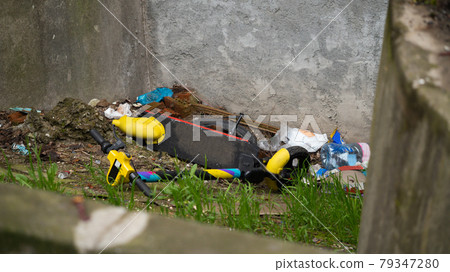 The electric scooter is thrown into the trash. The electric scooter public transport. The electric scooter is thrown into the trash. The electric scooter public transport. 79347280