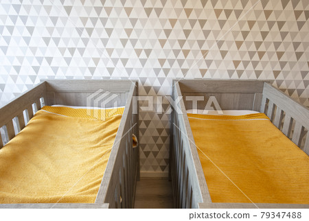 A Twin Bedroom with wooden baby beds for siblings, newborn babies modern stylish interior A Twin Bedroom with wooden baby beds for siblings, newborn babies modern stylish interior 79347488