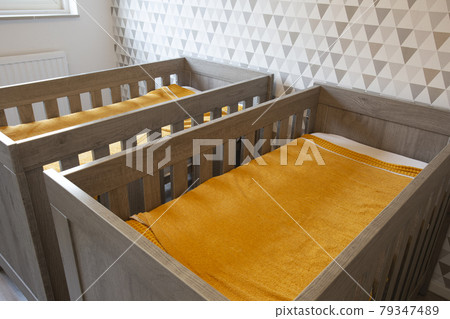 A Twin Bedroom with wooden baby beds for siblings, newborn babies modern stylish interior A Twin Bedroom with wooden baby beds for siblings, newborn babies modern stylish interior 79347489