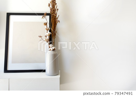 Empty wooden photo,picture frame mock-up with white vase and stylish plant near white wall on table, Copy space modern decoration interior Empty wooden photo,picture frame mock-up with white vase and stylish plant near white wall on table, Copy space modern decoration interior 79347491