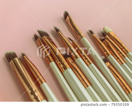 makeup brushes on pink cute background. makeup table for the princess. beauty with decorative cosmetics. fashionable and stylish makeup for a girl 79350109