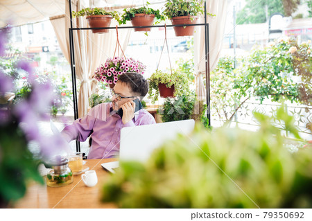 disabled man with wheelchair in restaurant eating 79350692