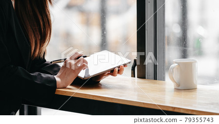 Close up business woman working with digital tablet on wooden desk with coffee morning 79355743