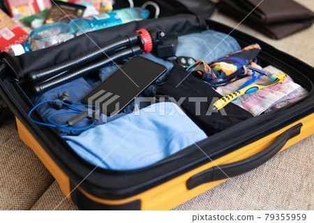 concept of collecting and packing things in suitcase, bag, baggage 79355959