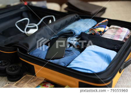 men's clothing packed in a suitcase 79355960