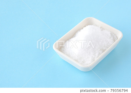 Salt on a light blue background Salt on a light blue background 79356794