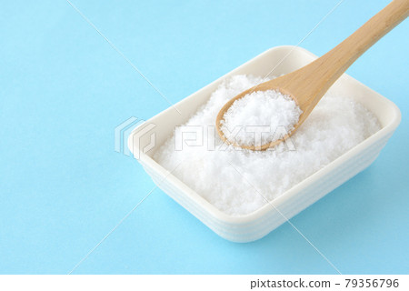 Salt on a light blue background Salt on a light blue background 79356796