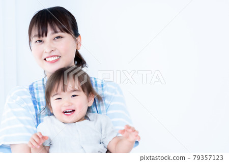 A girl and a nursery teacher who are hugged and spoiled A girl and a nursery teacher who are hugged and spoiled 79357123