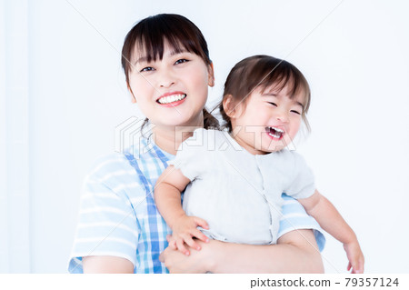 A girl and a nursery teacher who are hugged and spoiled A girl and a nursery teacher who are hugged and spoiled 79357124