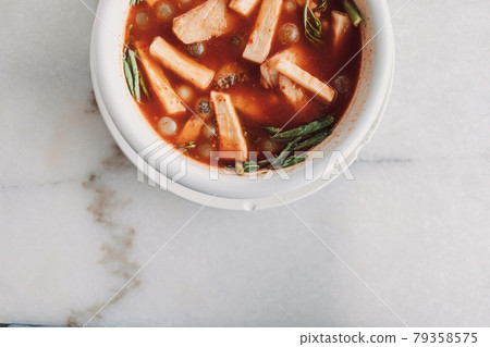 Thai Ryukyu Roe Sour Soup served in white bowl. 79358575