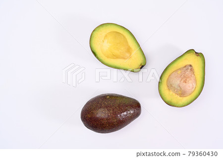 Top view whole and half avocado with seed on white background. Top view whole and half avocado with seed on white background. 79360430