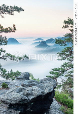 Wake up of misty sandstone mountains with the gradation of creamy clouds Wake up of misty sandstone mountains with the gradation of creamy clouds 79360688