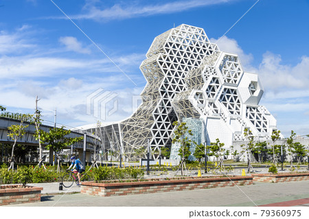 Kaohsiung Music Center with the view from Love River. The white hexagonal building structure on the riverbank in Kaohsiung, Taiwan. 79360975