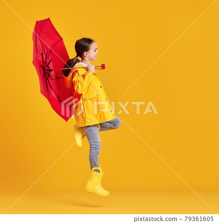 Happy kid with umbrella jumping in studio Happy kid with umbrella jumping in studio 79361605