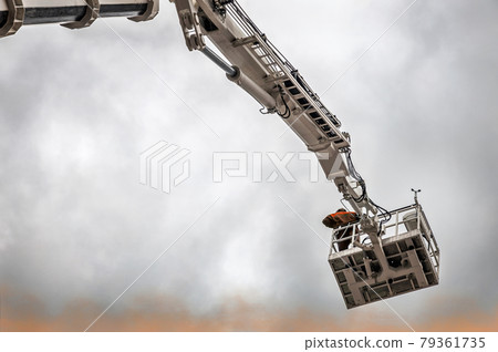 the automatic retractable boom of the fire truck crane and the fireman 79361735