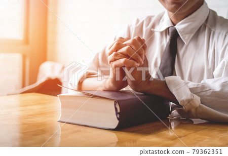 close up, the pastor laid hands on the black book of the Bible, Buddhist Catholic, Christian, prayer close up, the pastor laid hands on the black book of the Bible, Buddhist Catholic, Christian, prayer 79362351
