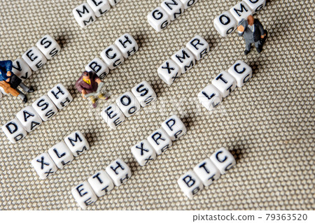set of popular crypto coins forming rows made of white cubes with black capital letters and miniature businessmen figurines having a team meeting 79363520