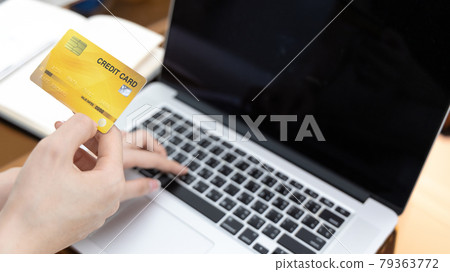 Asian woman lounging on sofa and using laptop to shop online with credit card to register for payment or online transactions, Financial transactions and Internet security, Shopping with credit card. Asian woman lounging on sofa and using laptop to shop online with credit card to register for payment or online transactions, Financial transactions and Internet security, Shopping with credit card. 79363772