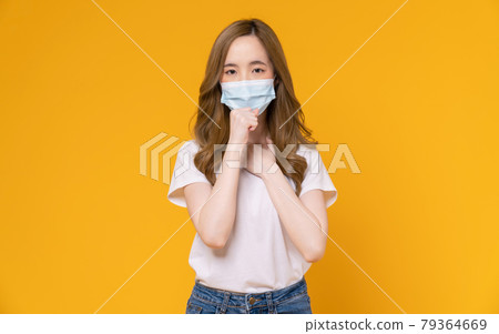 Asian woman wear masks to protect disease on yellow background. 79364669